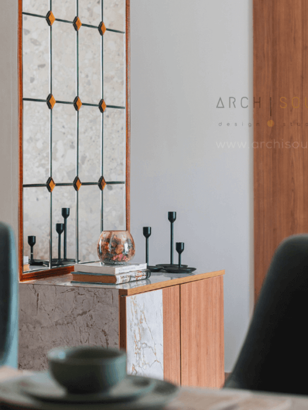 A modern room featuring a sleek marble vanity and a stylish mirror above it.