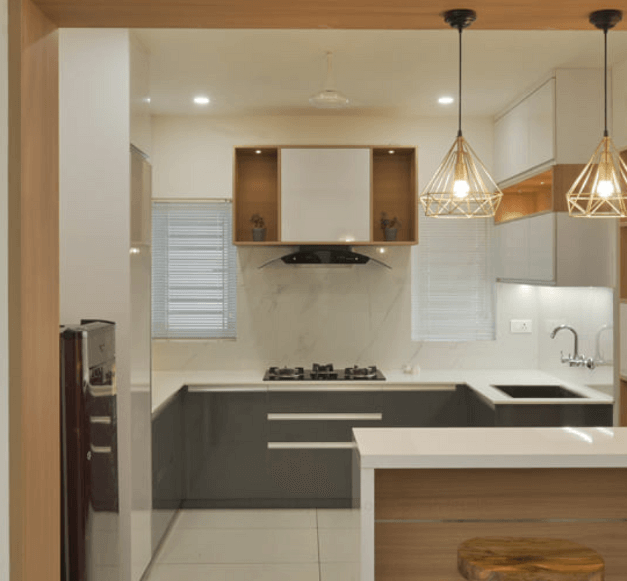 A modern kitchen featuring sleek white and wood cabinets