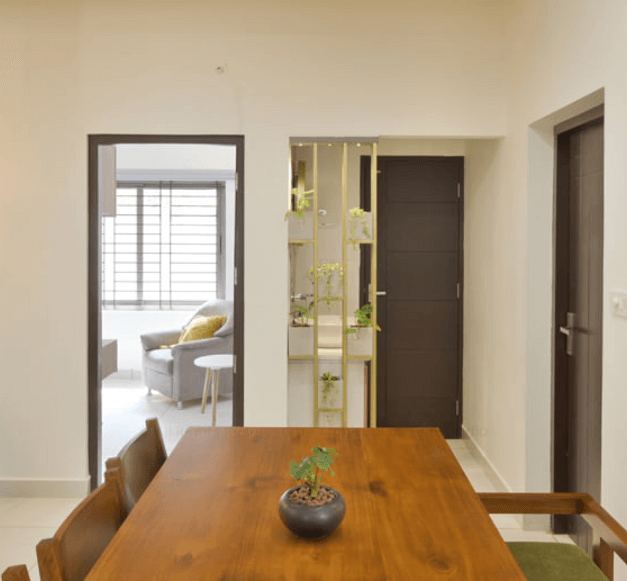 A wooden dining table surrounded by chairs in a bright room