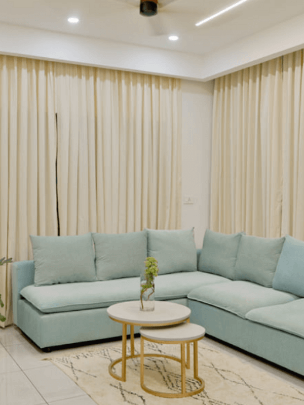 A cozy living room featuring a blue couch and a white table